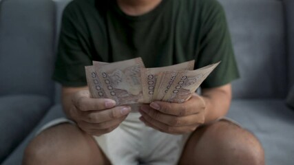 Close up of Asian man's hand counting Vietnamese dong currency