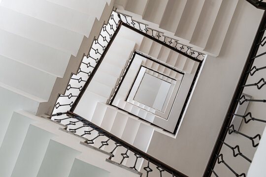 Captivating view of a white spiral staircase from above