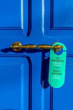 Blue door with a Do Not Disturb sign in a Mediterranean villa