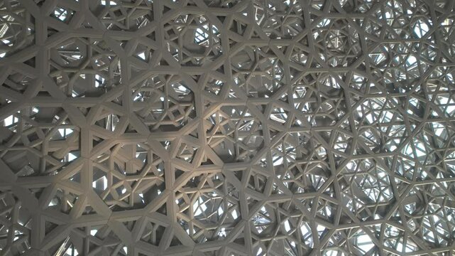 Abu Dhabi, United Arab Emirates - September 15, 2024: Lights passing through roof and ceiling of Louvre Abu Dhabi presenting Rain of Light design