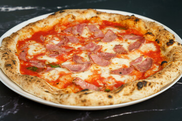 Original Italian pizza with ham, tomato sauce and cheese