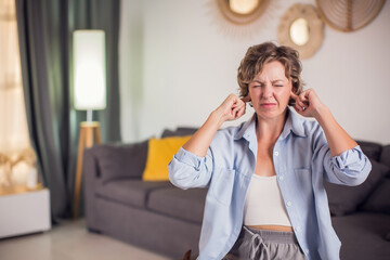Too much noise. Anxious woman shout stop cover ears with fingers unable to hear loud music, noisy...