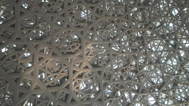Abu Dhabi, United Arab Emirates - September 15, 2024: Lights passing through roof and ceiling of Louvre Abu Dhabi presenting Rain of Light design