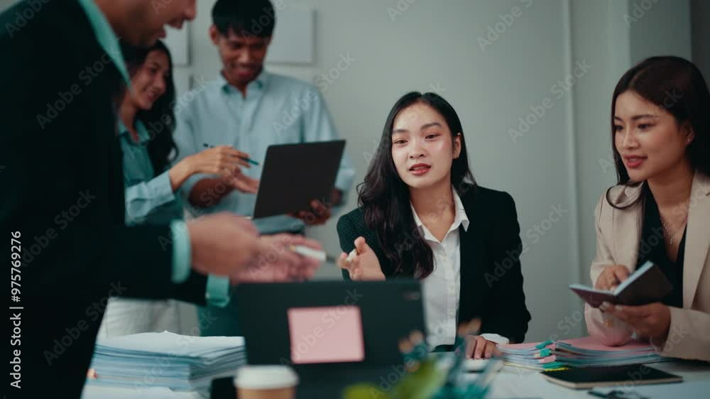 Poster businesswoman is leading a brainstorming session with her teammates. she is standing at the head of 
