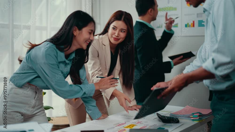 Poster two asian businesswomen are discussing a project during a meeting. they are smiling and appear to be