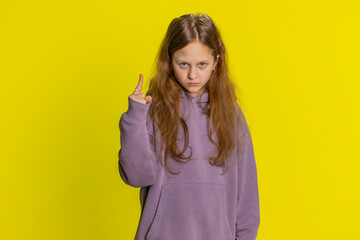 Quarrel. Displeased young cute redhead school girl gesturing hands with irritation and displeasure, blaming scolding for failure asking why this happened. Preteen female child kid on yellow background