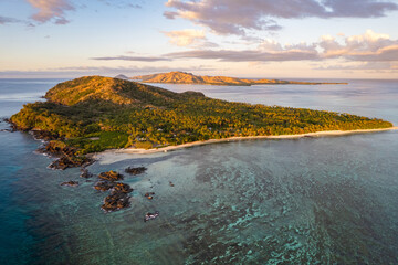 Beautiful sunrise above tropical Island coconut palm trees on remote island in the Pacific Ocean