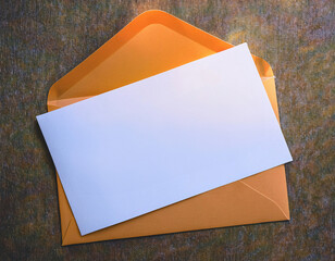An orange envelope with a white piece of paper on it