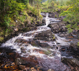 An autumnal landscape HDR of the River Etive flowing underneath Beinn Caitlin near Dalness in Glen Etive, Highlands, Scotland