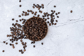 coffee beans in wooden bowl on concrete table