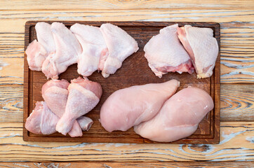 Raw mixed chicken meat parts  for cooking on rustic background