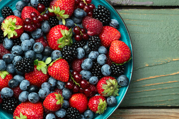 Mix of ripe colorful berries in bowl photography . Blueberry , strawberry , raspberry , blackberry...