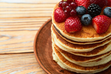 Stack of homemade american pancakes with berries . Top view