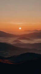 Fototapeta premium Sunrise Over Mountain Range with Fog