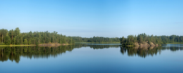 panorama of forest lake with reflections