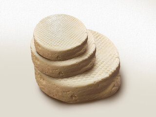 Fresh pressed whey cheese curd sitting on white background