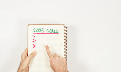  A caucasian men showing his third goal for 2025 years. Three goals for new year. Top view,...