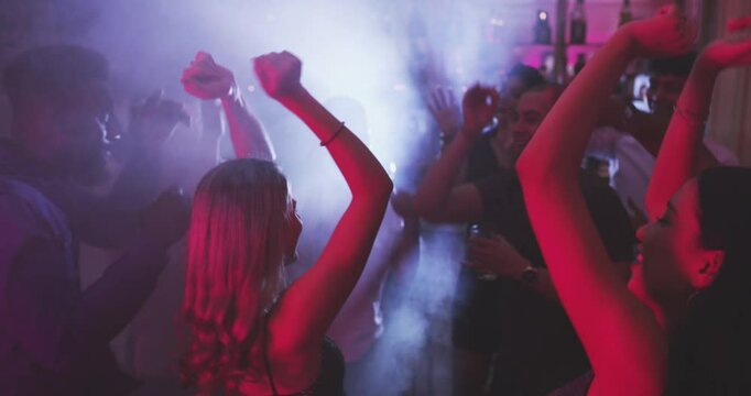 Dancing, nightclub and women with crowd for party, new years eve event and birthday rave. Music festival, disco and happy group of friends on dance floor for fun, celebration and concert in club