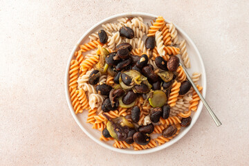 Gluten-free pasta with stewed beans and zucchini, offering a delicious and healthy vegetarian meal that's both satisfying and nutritious
