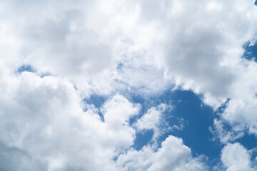 Sky background with dense white clouds on a bright day