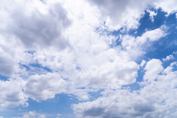 Sky background with dense white clouds on a bright day