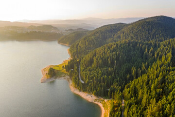 Scenic view of the mountains and the lake in the fog, Bulgaria. Mountain lakes surrounded by...
