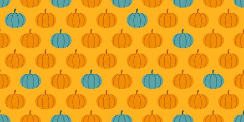Seamless autumn pattern with orange and green pumpkins on a warm yellow background. Gold harvest backdrop. Halloween, Thanksgiving Day, Harvest. Perfect for seasonal designs, textiles, wrapping paper.