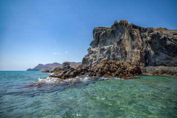 Idyllic ando rocky beach of Barronal with blue and transparent waters in the Natural Park of Cabo de Gata and Níjar in Almería, Andalusia, Spain.