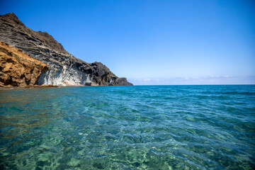 Idyllic ando rocky beach of Barronal with blue and transparent waters in the Natural Park of Cabo de Gata and Níjar in Almería, Andalusia, Spain.