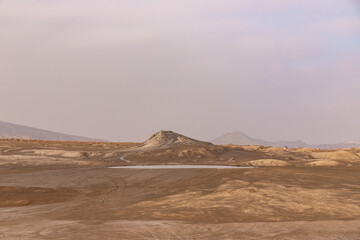 A round boiling lake of a mud volcano near the village of Alyat. Azerbaijan.