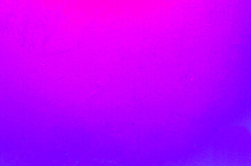 Old wall from gypsum plaster illuminated with nice neon purple light.