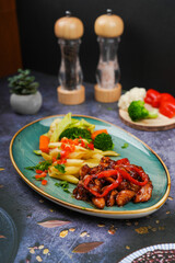 Veggie Pasta in a dish on a gray background, top view.