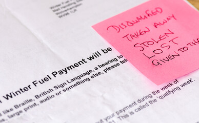 A Winter Fuel Payment cut concept with a letter and words written on a post it note.