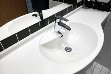 Modern Minimalist Bathroom Sink with Chrome Faucet and White Countertop