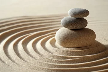 Selbstklebende Fototapeten Stack of three stones on rippled sand background. Minimalist zen garden for tranquility and mindfulness. © Amazing Kingdom
