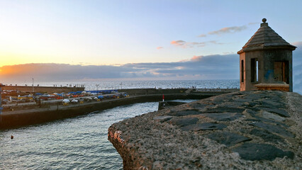 Old watchtower on the mole of El Penitente port de la Cruz at sunset. Puerto de la Cruz, Tenerife, Canary Islands, Spain, Europe. © Tony