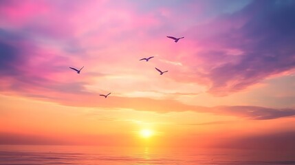 Obraz premium A stunning sunset scene with birds flying across the colorful sky, creating a serene and peaceful atmosphere in nature. 