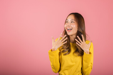 Asian happy portrait beautiful young woman teen stand surprised excited celebrating open mouth gesturing palms on face isolated, studio shot pink background with copy space, positive expression