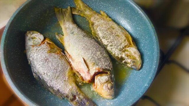 Frying fish in a frying pan. Tasty homemade roasted crucian carp 