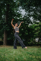 A woman practicing yoga in a tranquil forest setting, demonstrating balance and concentration. Surrounded by lush greenery, she embodies peace and mindfulness.