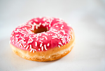 Conceptional bakery stillife of pink donut isolated