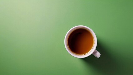 A cup of coffee on a green background.
