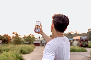 a man who is taking photos of himself and nature in various styles. the man has his back to the...