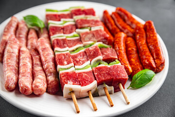 raw sausage meat assorted juicy pork, beef fresh gourmet food background on the table rustick food top view copy space