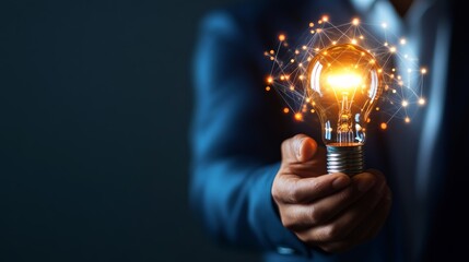 Innovative concept image of a light bulb held by a businessperson, symbolizing creativity, new ideas, and inspiration in a corporate setting.