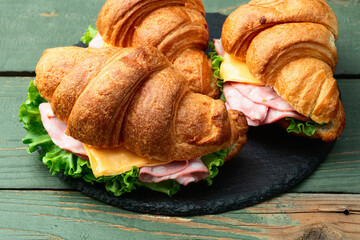 Croissant sandwich with salad ham and cheese . Top view