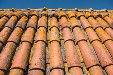 Clay tiles. Close-up of a clay tile roof against a blue sky