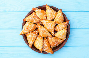 Homemade triangle puff pastry with meat on rustic background . Samosa