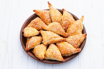 Homemade triangle puff pastry with meat on rustic background . Samosa