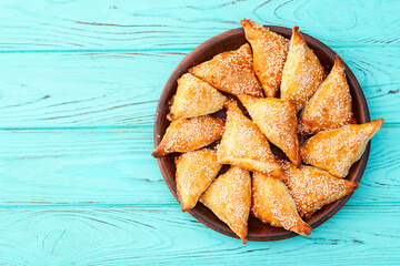 Homemade triangle puff pastry with meat on rustic background . Samosa